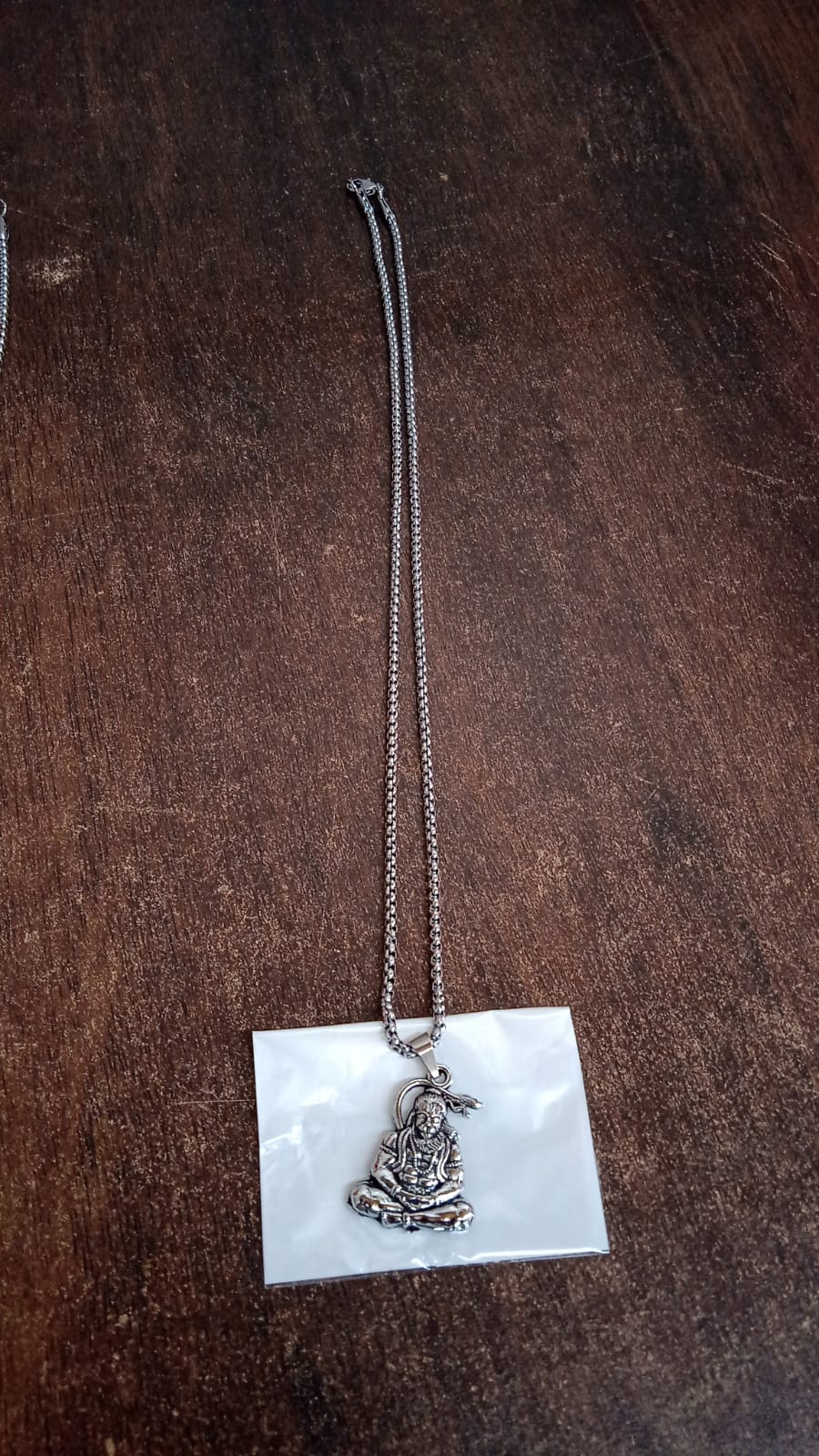 Hanuman Ji pendant necklace with detailed charm on a silver chain for spiritual wear