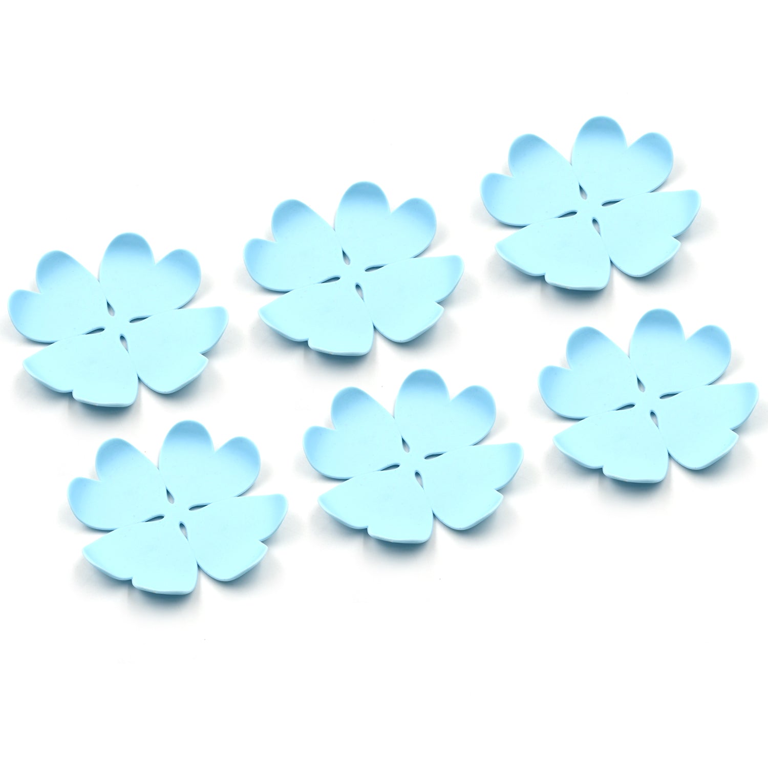 Set of six blue flower-shaped heat resistant coasters set for protecting surfaces from hot drinks
