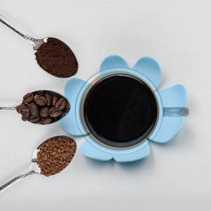 Blue floral heat resistant coasters set with coffee grains and a cup of black coffee