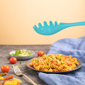 Heat resistant pasta fork in turquoise color serving pasta on a gray plate with fresh vegetables