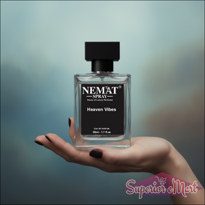 Nemat Heaven Vibes 50ml Eau de Parfum: clear glass bottle with black cap and label, held in hand.
