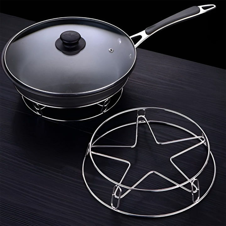 Heavy duty stainless steel gas stove stand with a black frying pan and glass lid on a dark surface