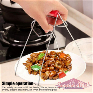 Stainless steel dish gripper tongs in use, lifting a plate of food safely from the kitchen counter.