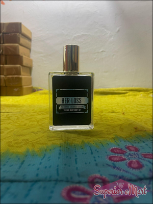 Her Loss signature perfume bottle with elegant design on a vibrant yellow background