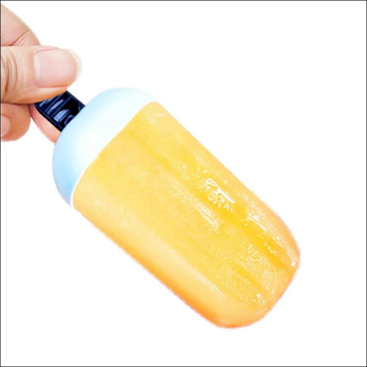 Hand holding a bright orange ice candy mould for making homemade frozen treats