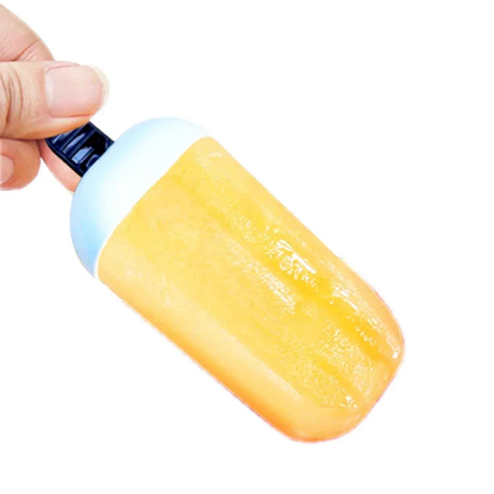 Hand holding a bright orange ice candy mould for making homemade frozen treats