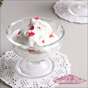 Clear glass ice cream dessert bowl set with whipped cream and colorful toppings