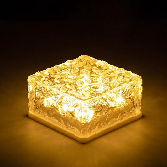 Ice cube shaped outdoor lights providing warm illumination for garden spaces and pathways