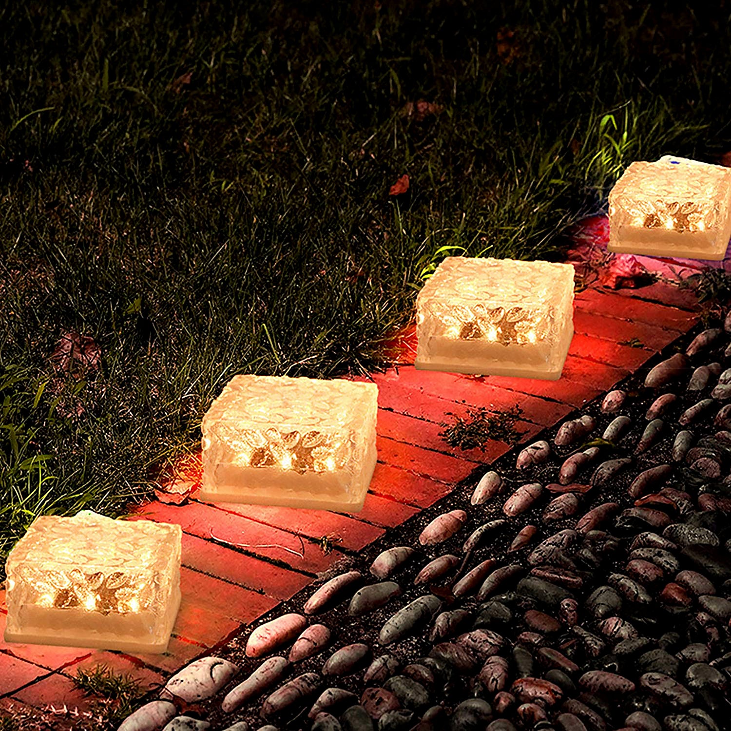 Ice cube shaped outdoor lights illuminating a garden pathway with a warm glow