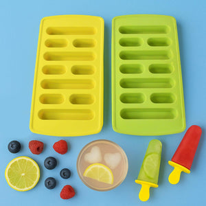 Bright yellow and green ice cube tray set with fruits and colorful popsicles on a blue background