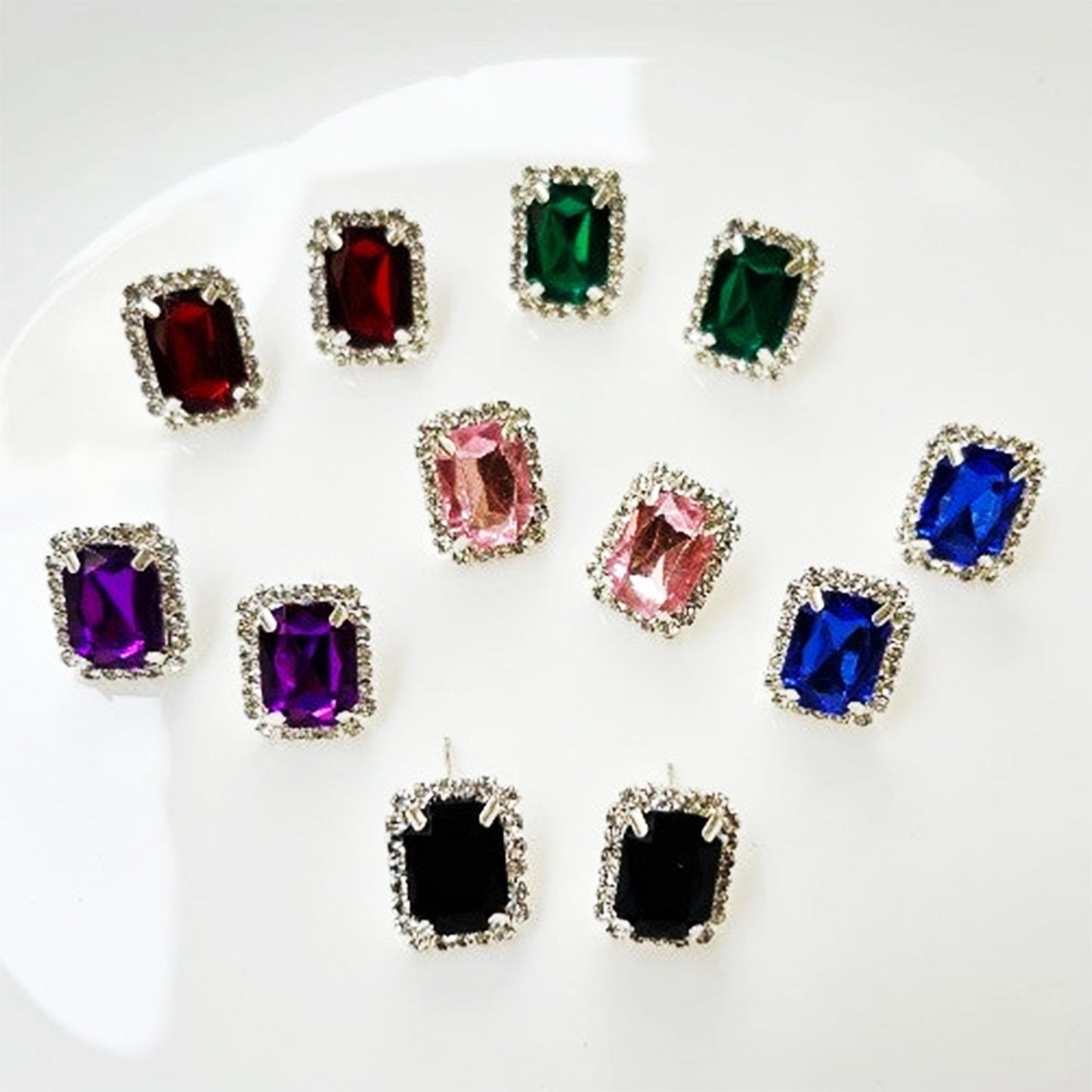 Set of interchangeable diamond earrings in various colors, perfect for versatile styling options