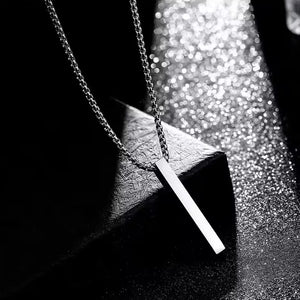 Elegant stainless steel locket necklace on a textured background with a sleek design