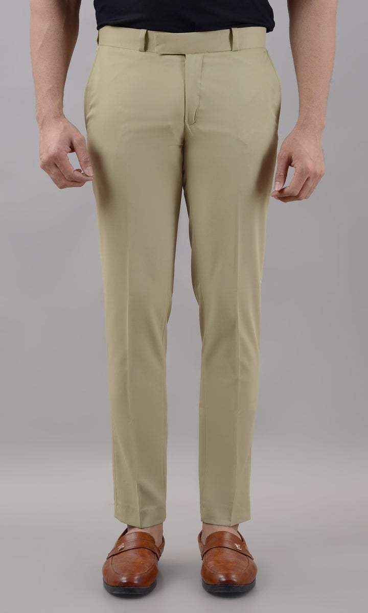 Beige pants worn by a person on a plain background