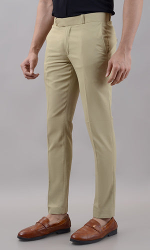 Beige pants worn by a person on a plain background