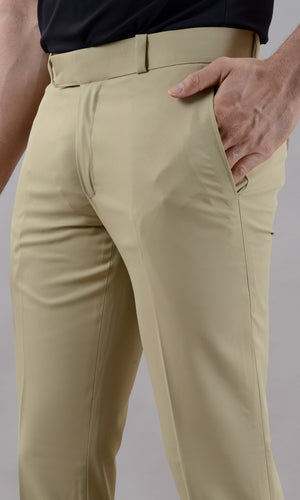 Beige pants worn by a person on a gray background