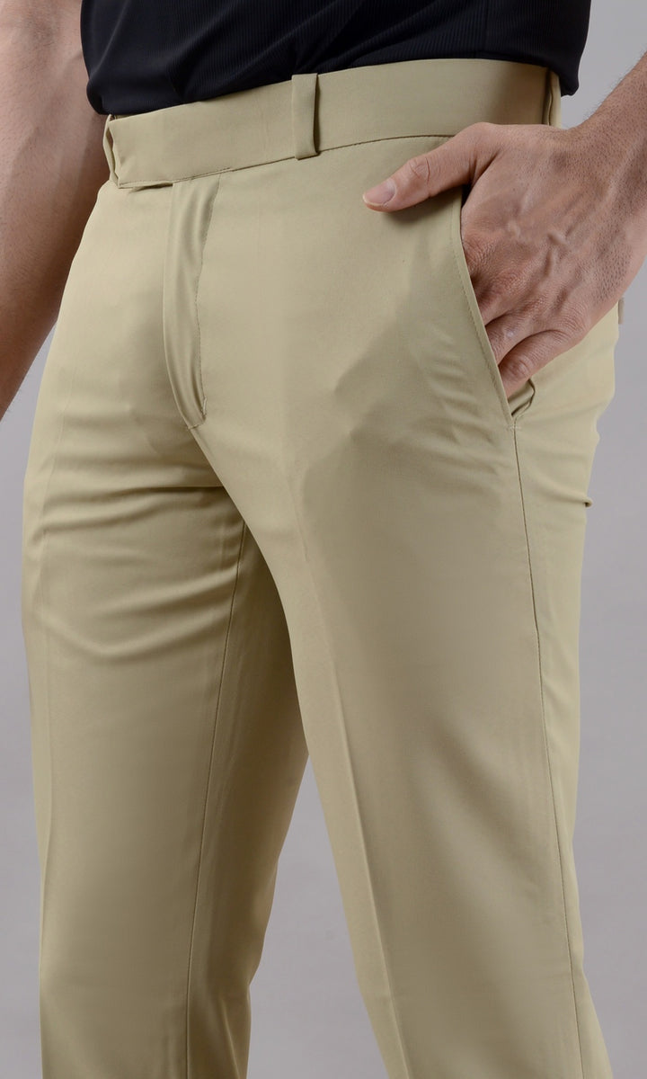 Beige pants worn by a person on a gray background