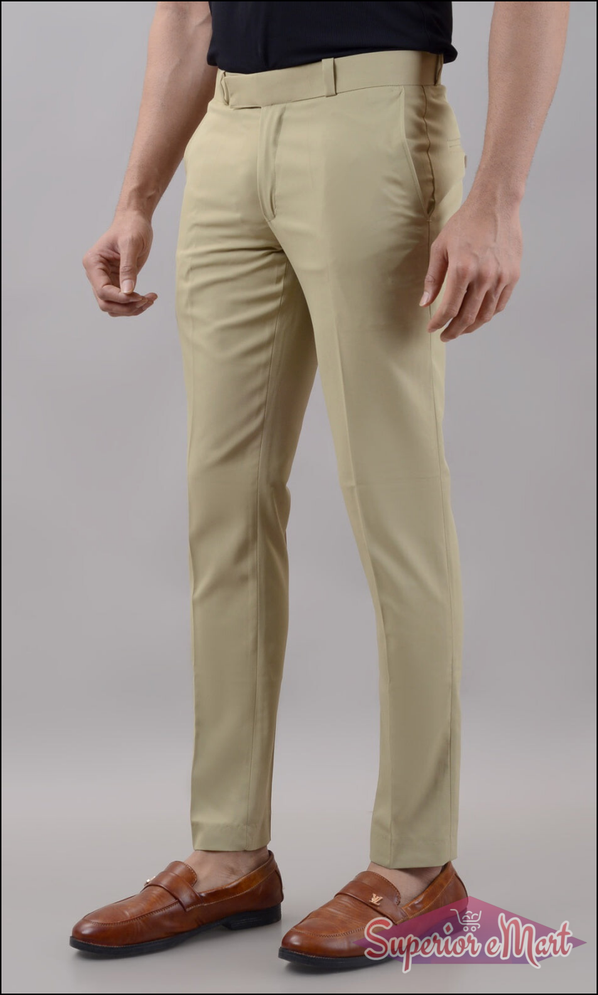 Beige pants worn by a person on a plain background