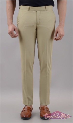 Beige pants worn by a person on a plain background