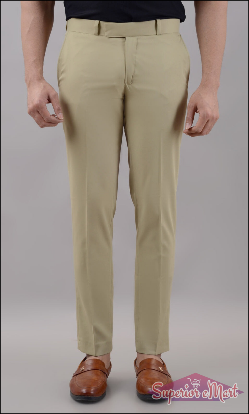 Beige pants worn by a person on a plain background