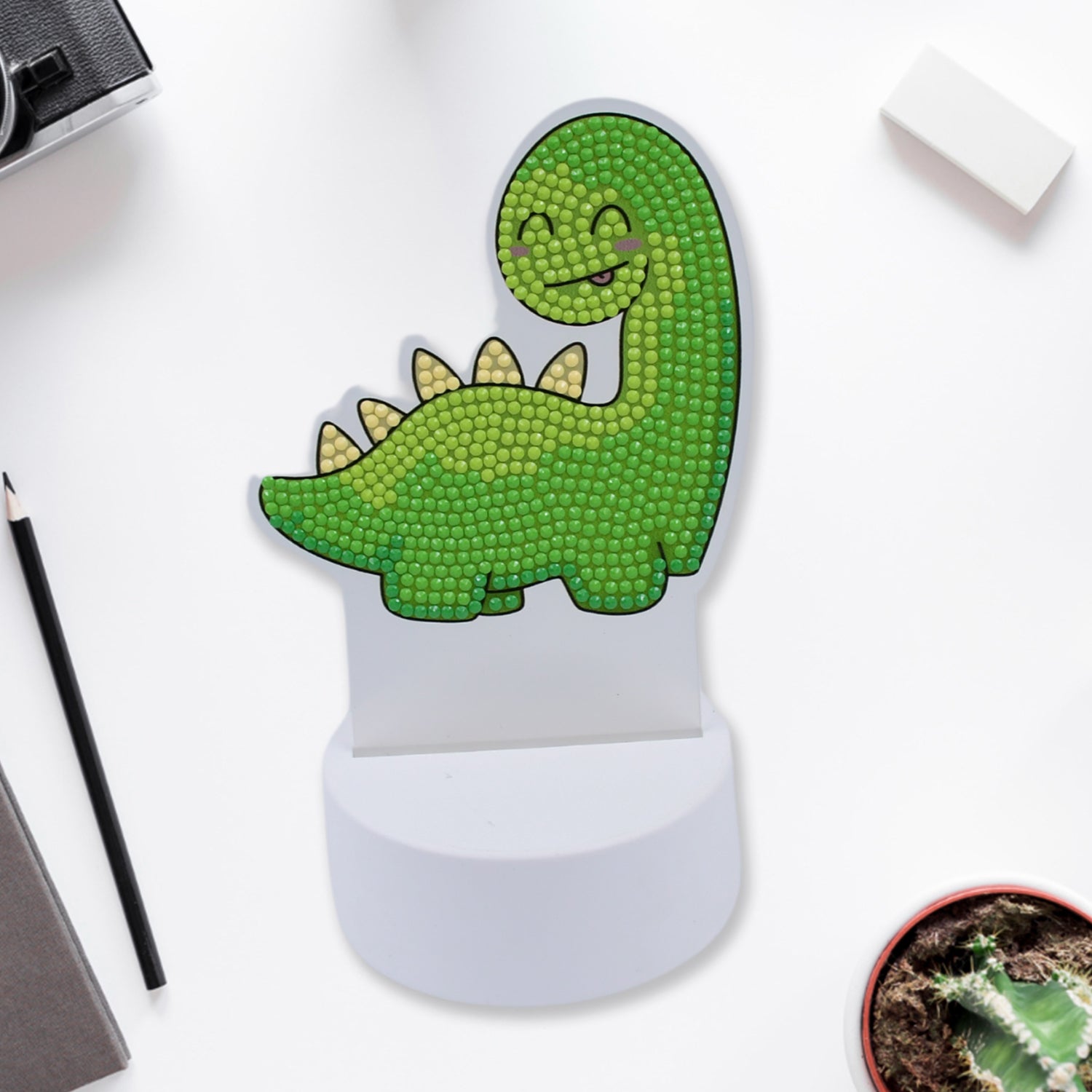 Kids night light dinosaur in green with a smiling face for fun nighttime illumination