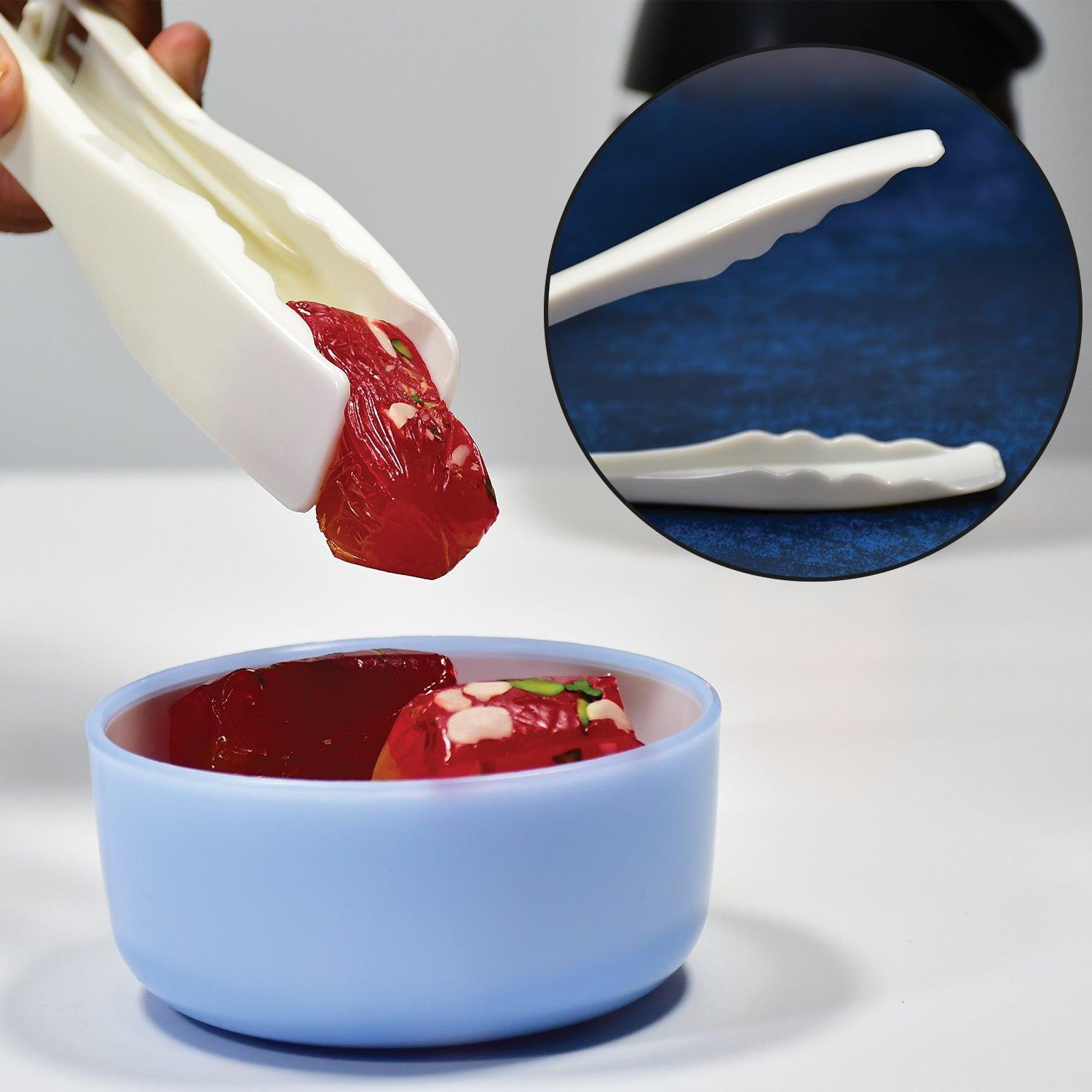 Superior eMart kitchen bread tongs gripping gelatin dessert in a blue bowl for easy serving
