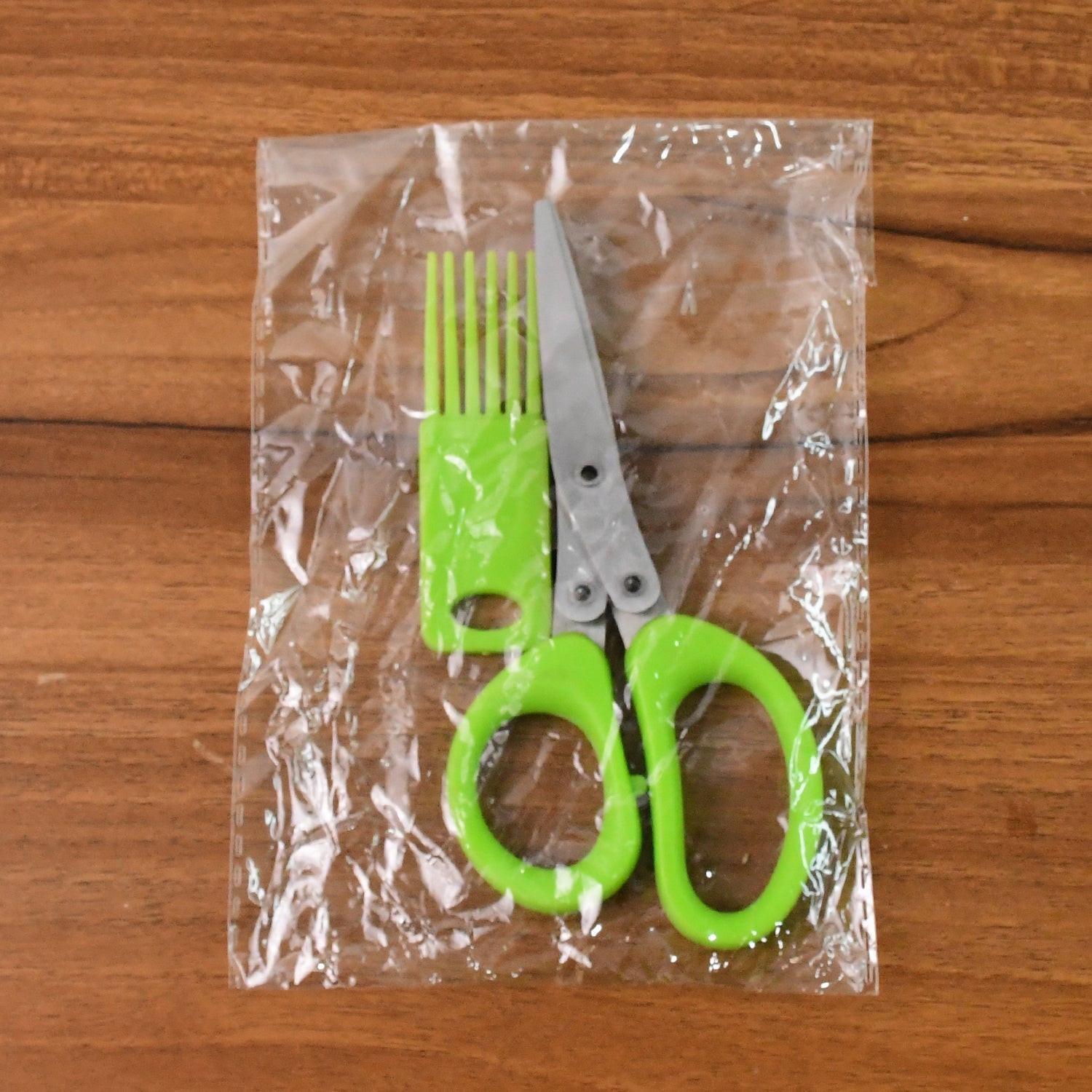 Green multipurpose kitchen scissors packaged with a safety cover for home cooking tasks