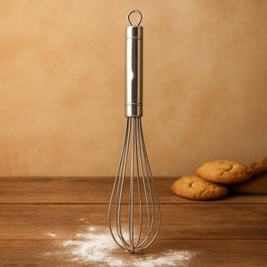 Stainless steel hand whisk with a sturdy handle, perfect for blending batter and whipping cream