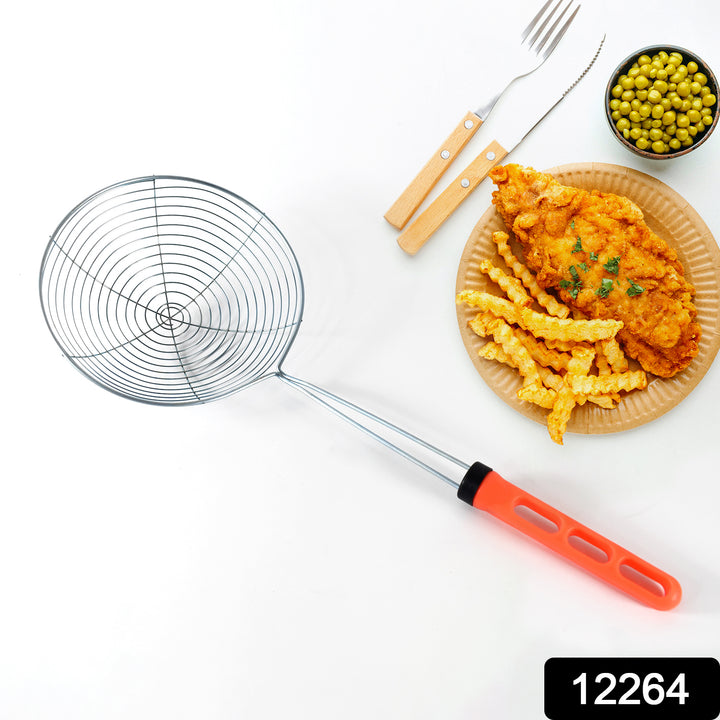 Stainless steel fry strainer with orange handle next to plate of fried chicken, fries, and peas