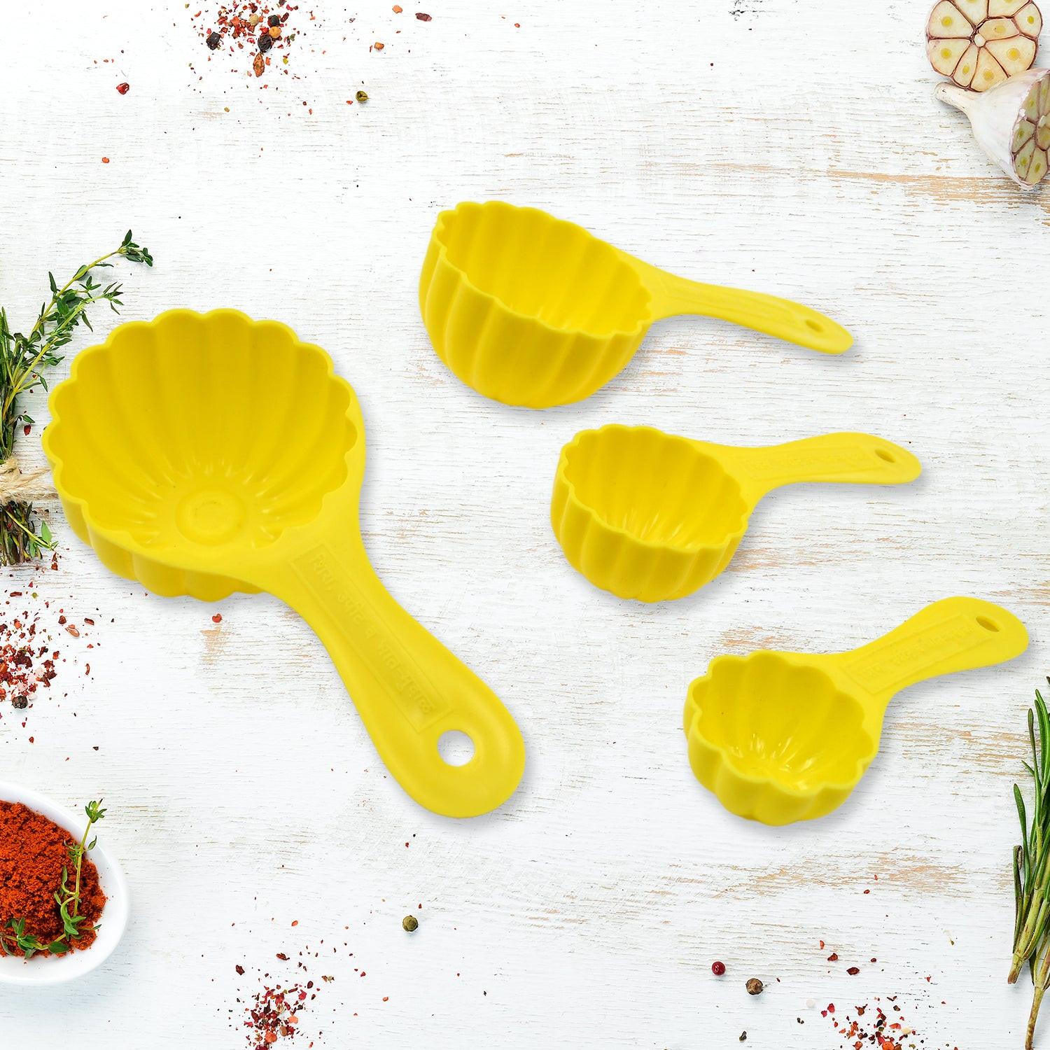 Yellow ladoo mould spoon set for making shaped sweets and snacks in the kitchen