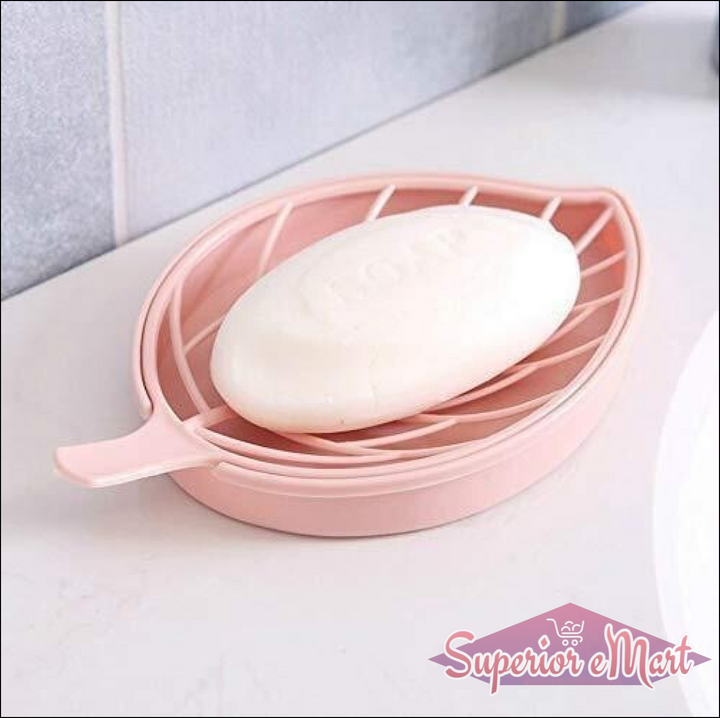 Leaf shape soap holder in pink with a bar of soap resting on its slotted surface