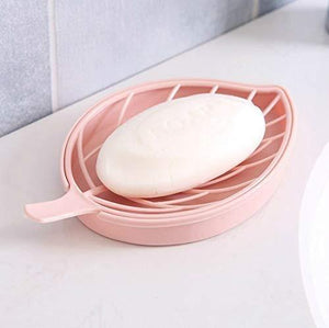 Leaf shape soap holder in pink with a bar of soap resting on its slotted surface