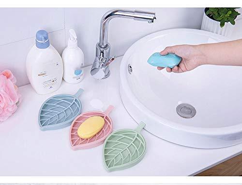 Set of leaf shape soap holders in pastel colors arranged by a sink for bathroom organization