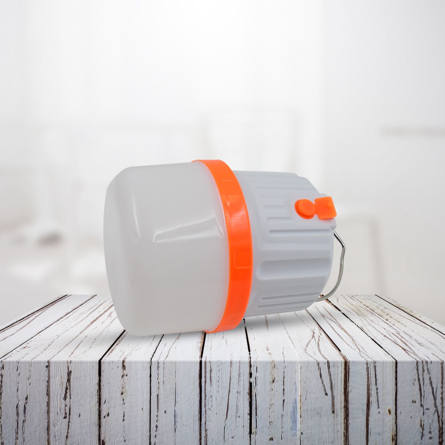 Compact LED camping light with orange accents for outdoor adventures and emergency use