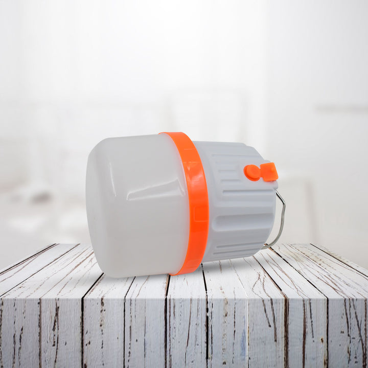 Compact LED camping light with orange accents for outdoor adventures and emergency use