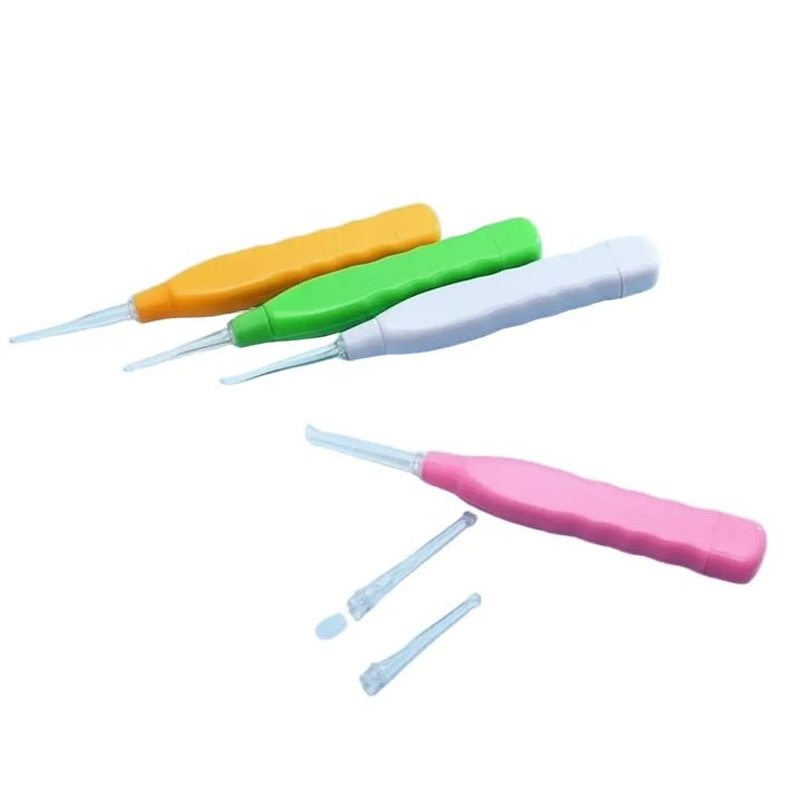 Colorful plastic earwax removal tools in orange, green, white, and pink with contoured handles and clear tips.