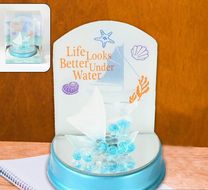 Decorative ocean-themed display featuring 'Life Looks Better Under Water' text with a sailboat and seashells