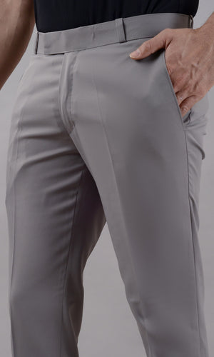 Gray pants worn by a person on a plain background