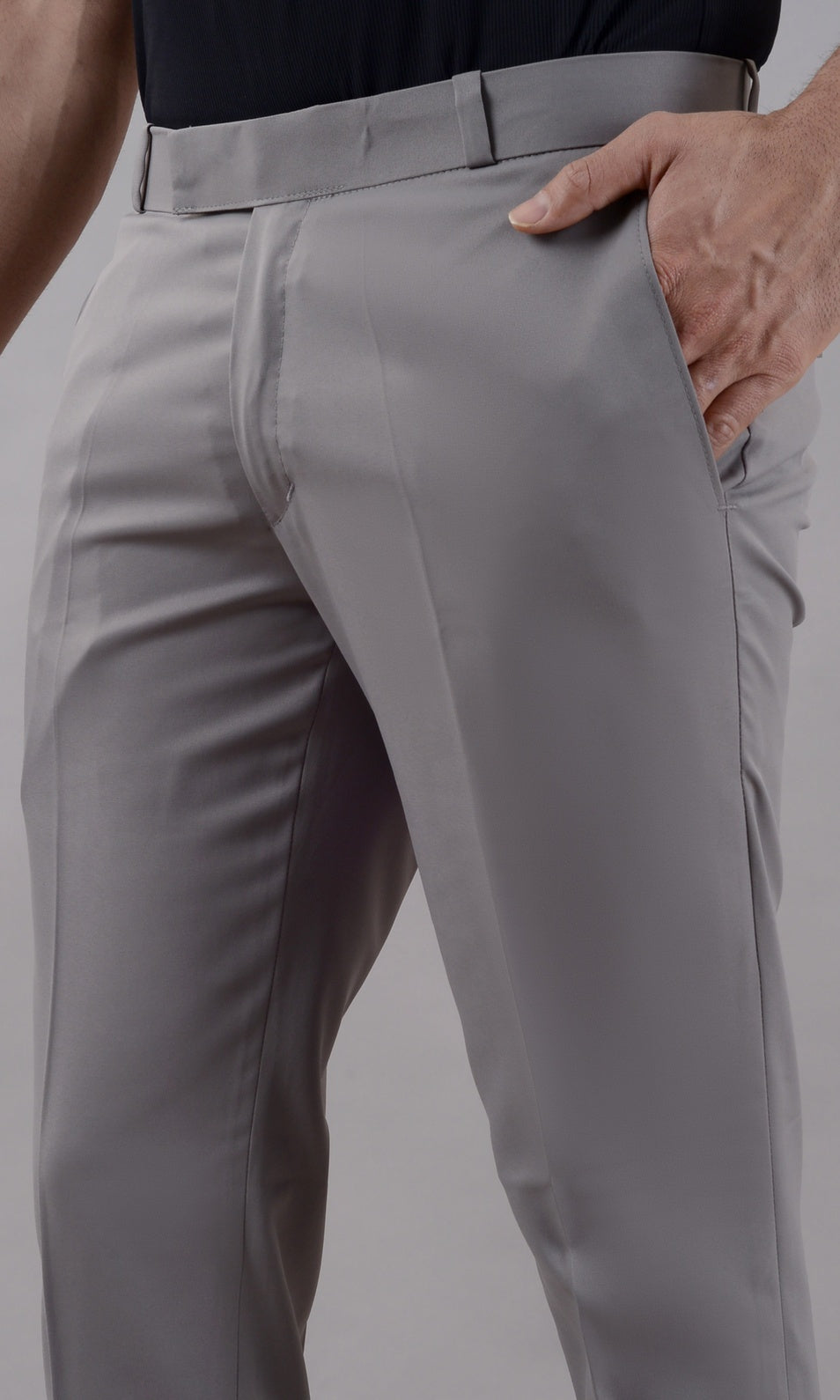 Gray pants worn by a person on a plain background
