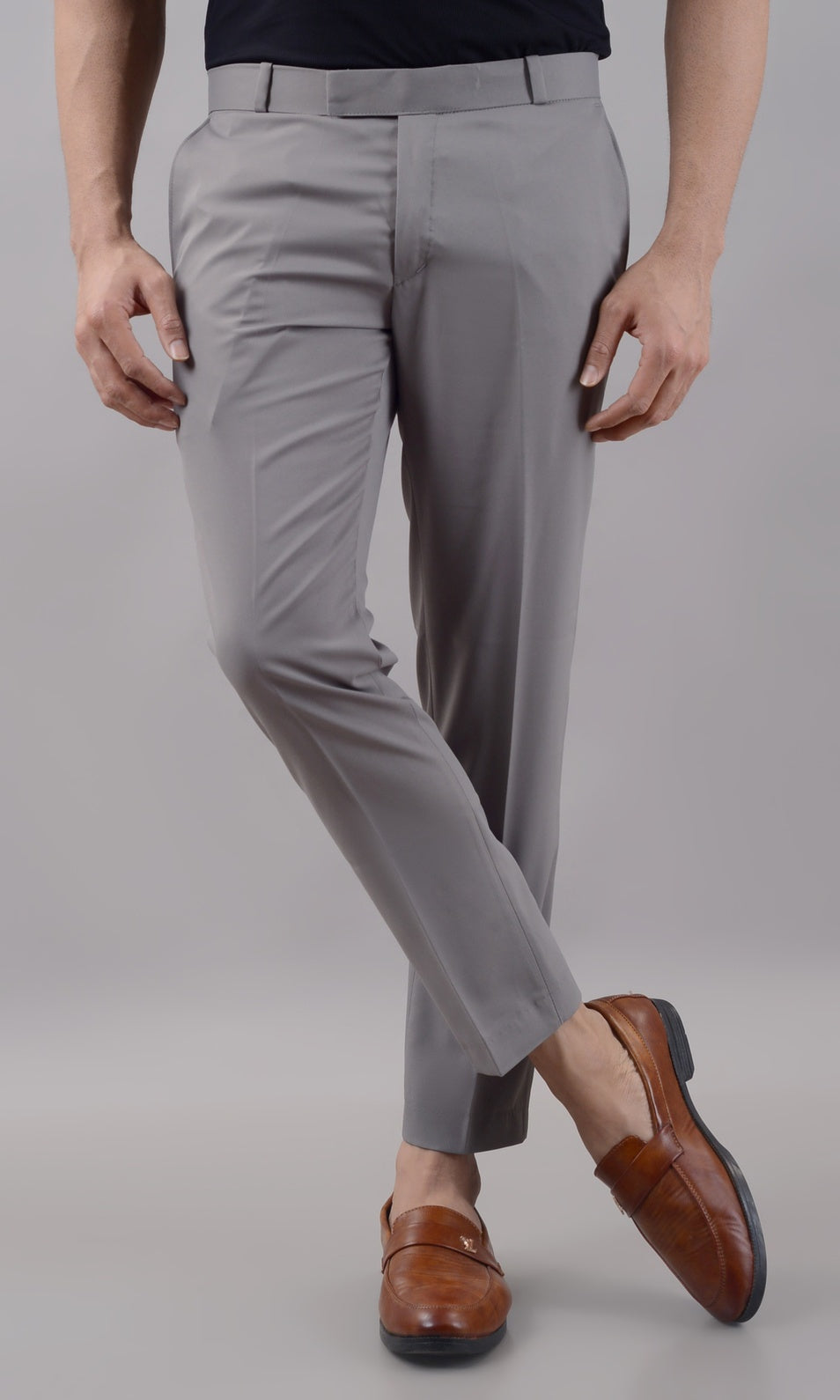 Gray pants worn by a person on a plain background