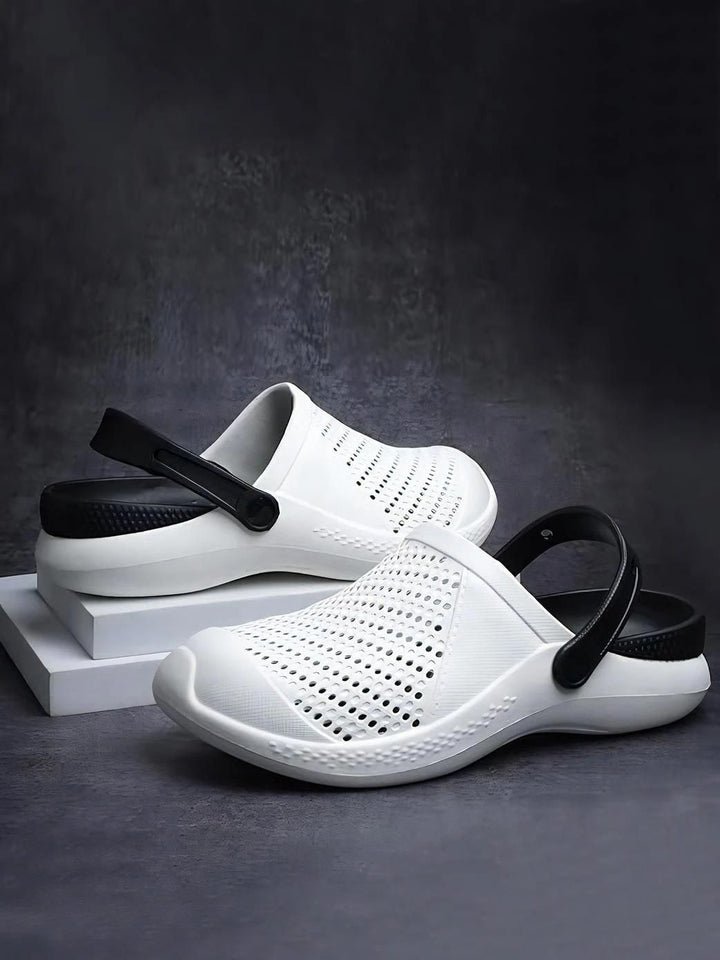 White lightweight casual clogs for men with black adjustable heel straps and perforated upper