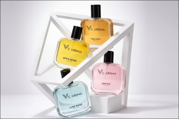 Four VX Aroma perfume bottles on a white geometric shelf