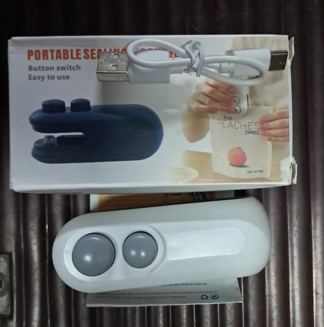 Magnetic heat sealer with cutter in white, featuring button switch and USB cable for easy use