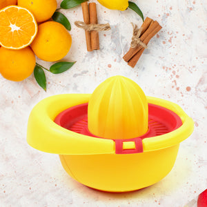 Bright yellow manual citrus juicer 300ml with a half orange and cinnamon sticks in the background
