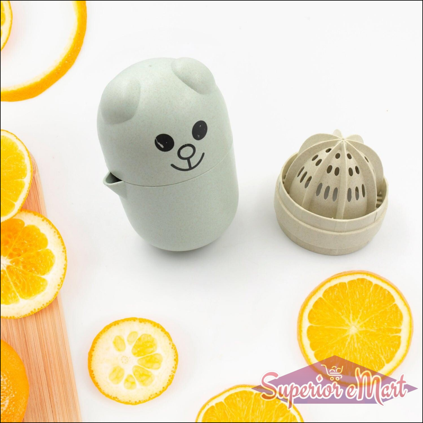 Cute green manual citrus juicer shaped like a bear with citrus slices on a wooden board