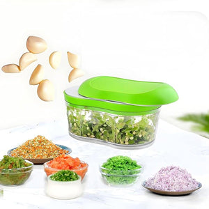 Manual garlic chopper with green lid and clear container, ideal for chopping garlic and herbs quickly