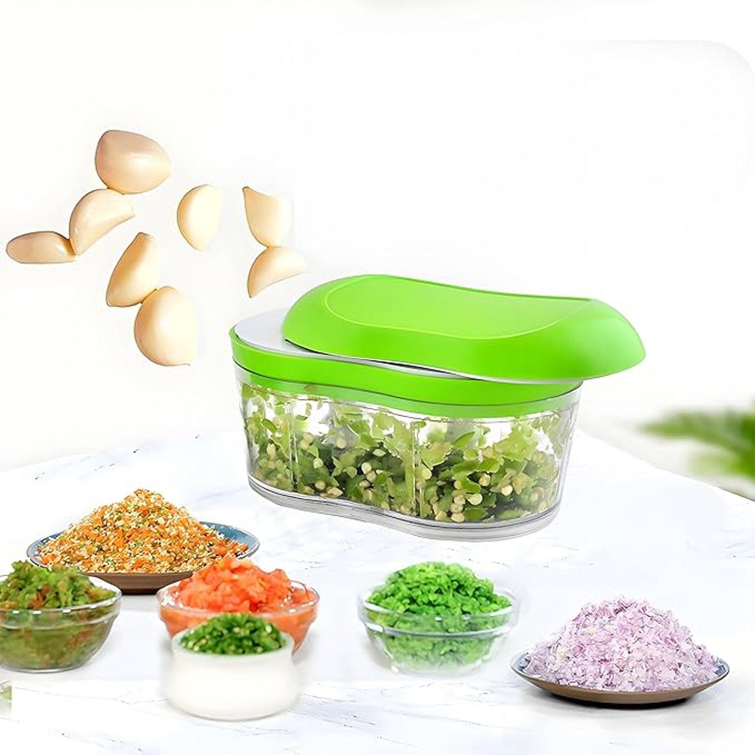 Manual garlic chopper with green lid and clear container, ideal for chopping garlic and herbs quickly