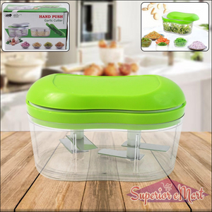 Manual garlic chopper with a green lid for easy herb and garlic chopping in the kitchen