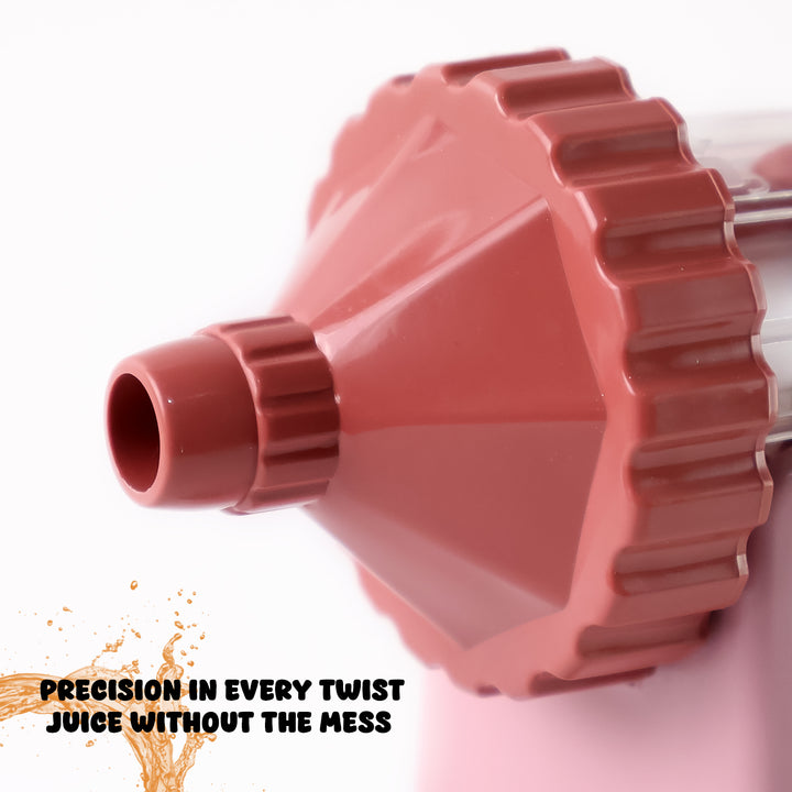 Close-up of red manual juicer for home use showing precision twist design for mess-free juice extraction