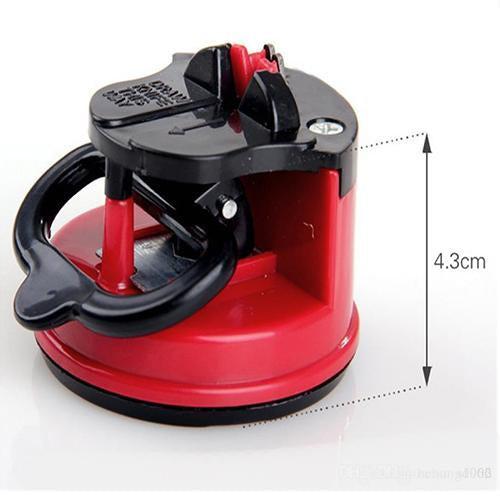 Manual kitchen knife sharpener in red and black, designed for effective sharpening with a compact design