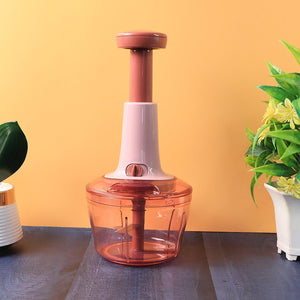 Manual vegetable chopper with easy-grip handle and transparent bowl for efficient food preparation